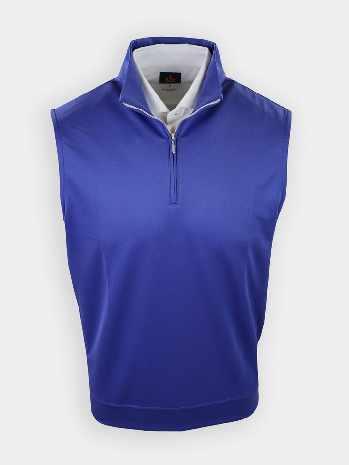 A sleeveless, zip-up blue golf shirt is displayed against a white background.
