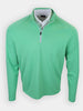 A long-sleeved, green athletic shirt is displayed with a quarter-zip collar.