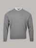 A gray crew-neck pullover with a subtle pattern is displayed on a plain background. A white shirt collar is visible above the neckline.