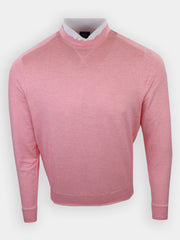 A light pink long-sleeved garment with a high collar and a white shirt collar underneath is displayed against a neutral background.