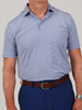 Man wearing a light blue striped polo shirt paired with navy pants and a brown belt, conveying a casual and polished look.