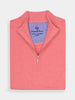 Folded coral half-zip sweater, with a ribbed collar and silver zipper, atop a white surface