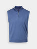 Blue sleeveless vest with a quarter-zip collar. Features a ribbed hem and soft texture, giving a casual and comfortable look