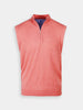 A coral-colored, sleeveless sweater vest with a quarter-zip collar is centered against a white background