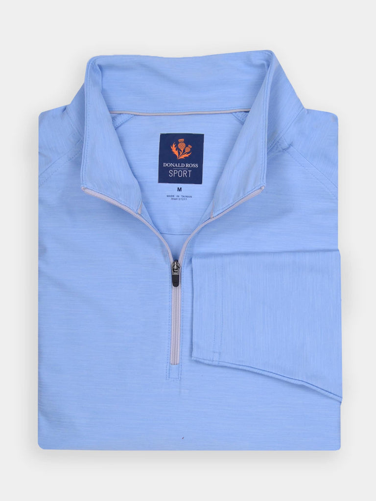 Light blue quarter-zip golf pullover folded neatly with collar open