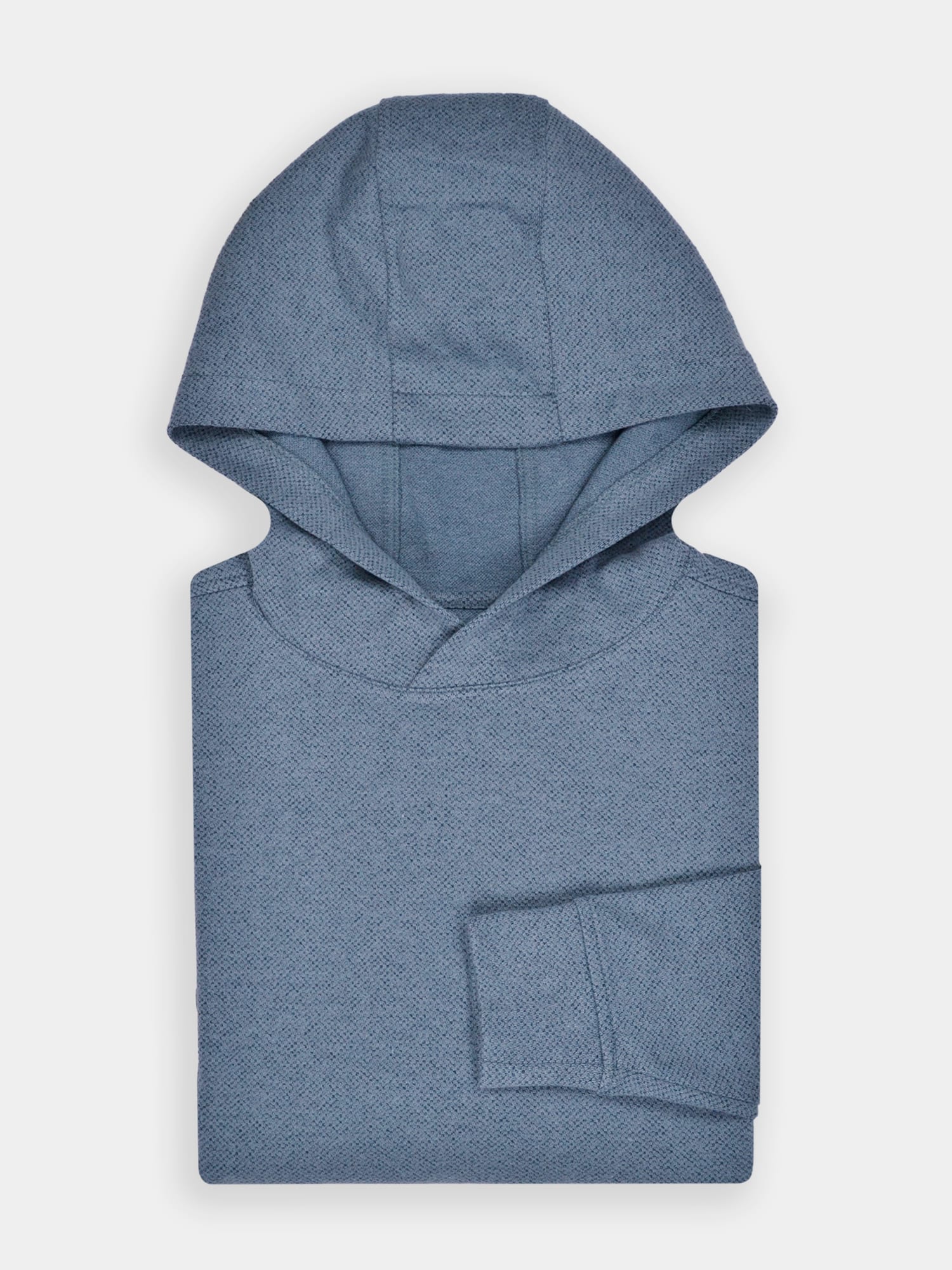 Folded light blue hooded golf sweatshirt on a plain white background. The performance fabric has a subtle textured pattern