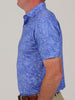 Side profile of a person wearing a blue floral patterned shirt and beige pants. The shirt features a subtle flower design, conveying a relaxed style.
