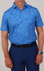 A person wearing a blue, short-sleeved, floral-patterned button-up shirt with navy pants and a black belt. A watch is visible on the left wrist.