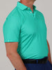 Mitchel club and ball print, a garment featuring a close-up of a light jade performance polo shirt showing the detailed golf club and ball pattern and a three-button placket.