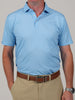 Man in a light blue polo shirt and khaki pants. He wears a brown belt, silver wristwatch, and stands against a neutral background. Casual and neat appearance.