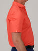 A person is facing slightly to the right while wearing a bright orange short-sleeve polo shirt.