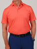 Man wearing a bright coral polo shirt and navy blue pants, framed from the shoulders to hips. The style is casual and neatly tucked in.