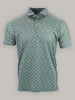 Green short-sleeve polo shirt featuring a small yellow shark pattern. The shirt has a collar and three white buttons, giving it a casual, summery feel.