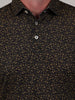 Close-up of a black shirt with a gold football inspired print. The shirt has a button-down collar and two buttons visible.