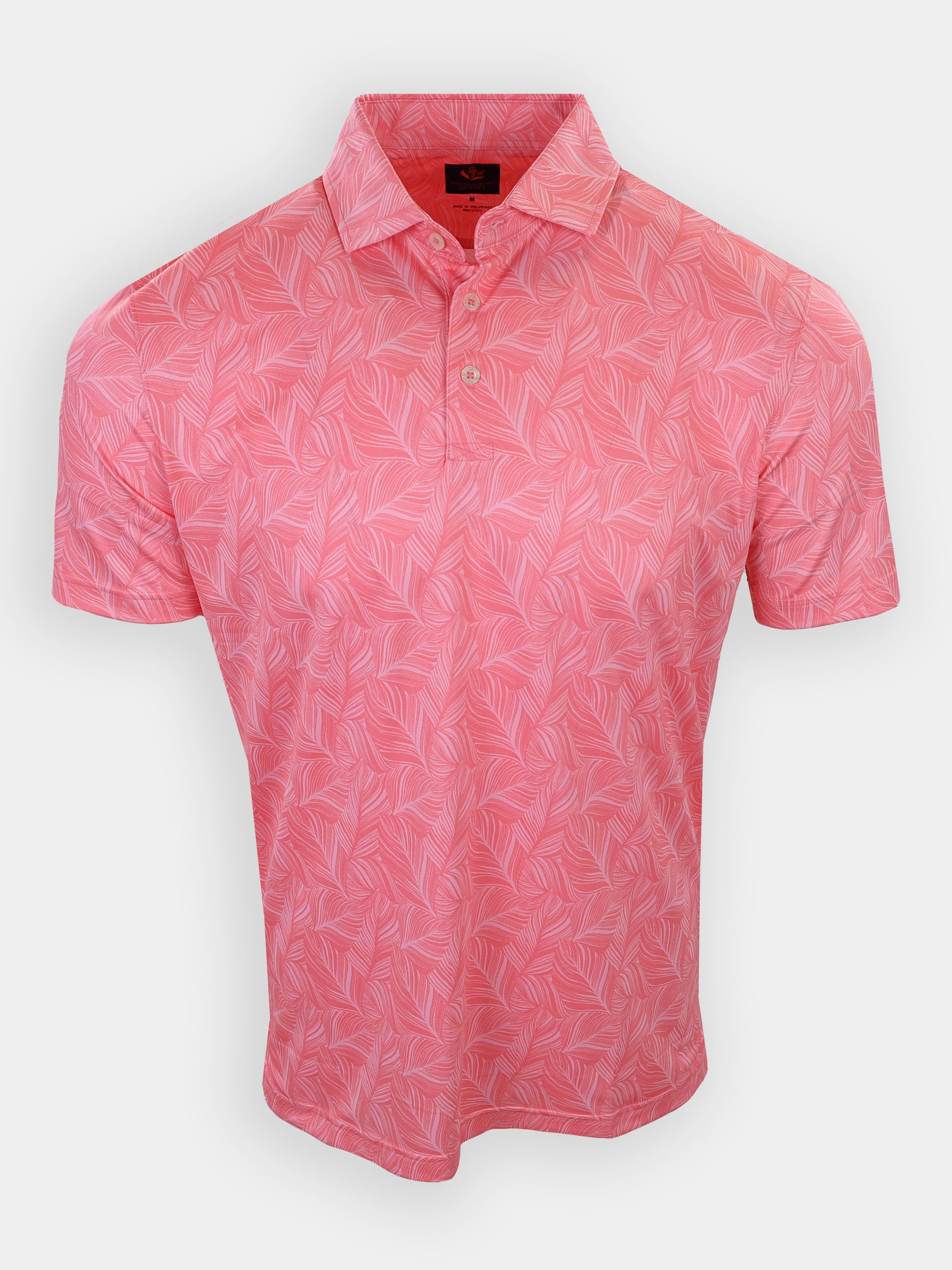 Short-sleeved, pink polo shirt with a leaf pattern is displayed on a plain background.