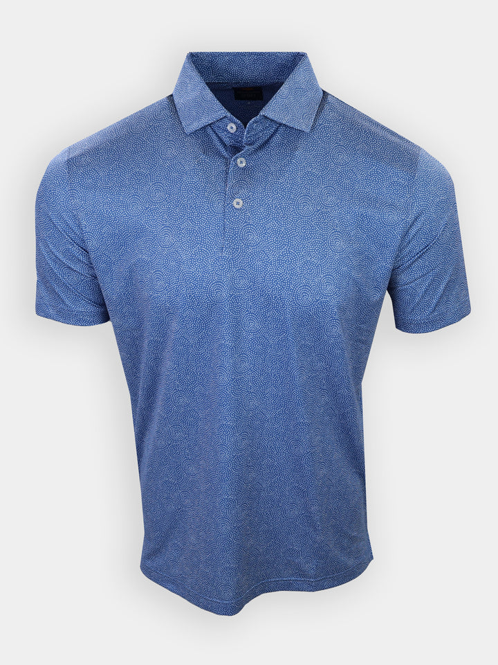 A blue polo shirt with a patterned design and a collar is displayed against a plain background.
