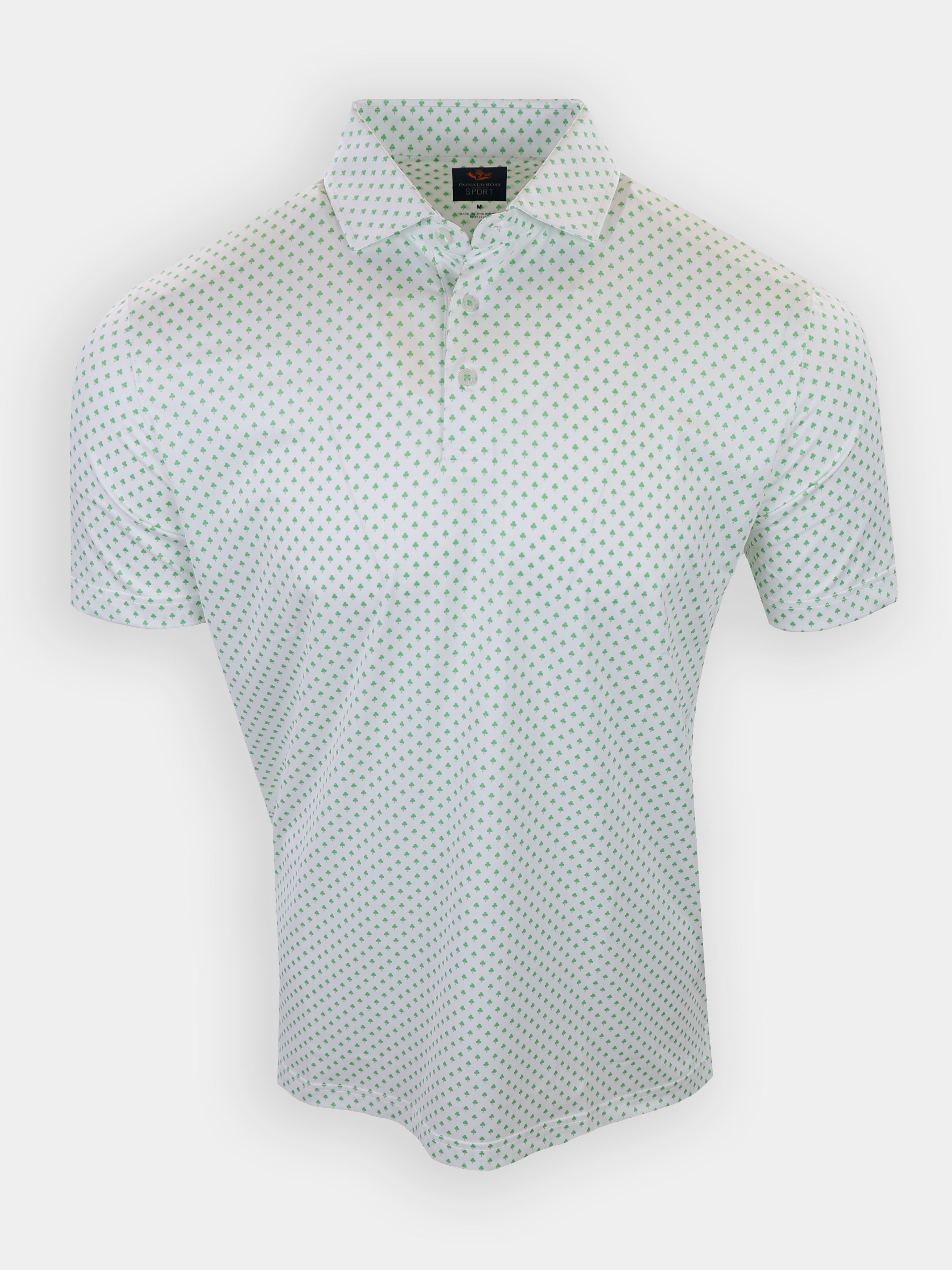 A short-sleeved polo shirt with a white base and green polka dots is displayed against a plain background.