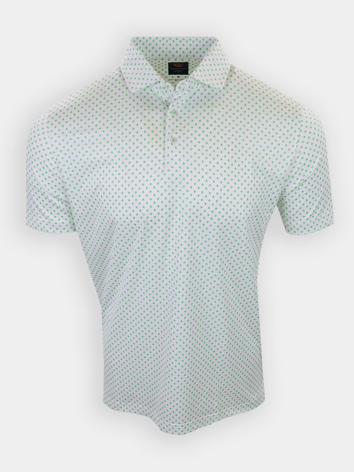 A short-sleeved polo shirt with a white base and green polka dots is displayed against a plain background.