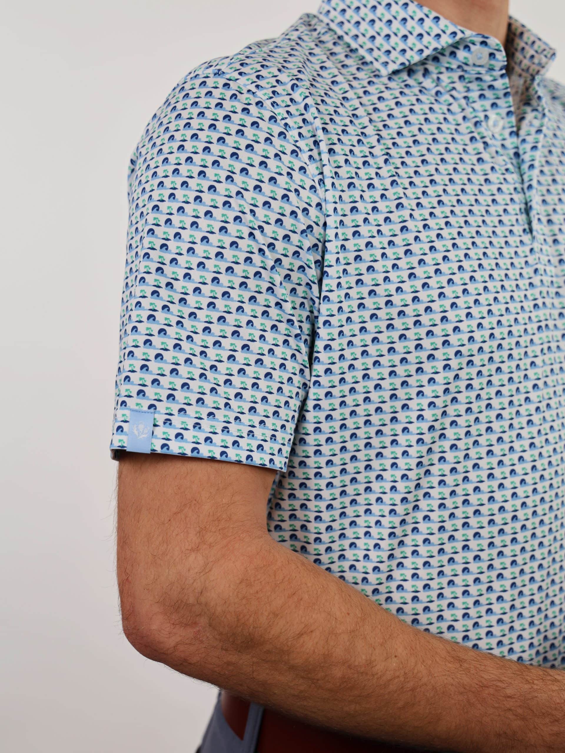 A person wearing a light blue patterned short-sleeve shirt with high tide design