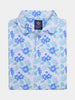 Folded polo shirt featuring a vibrant blue floral and green leaf pattern on a white background
