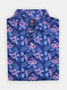 Folded navy blue floral polo shirt featuring a pattern of pink hibiscus flowers and light blue leaves