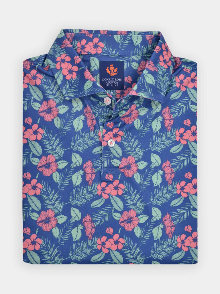 Blue polo shirt with vibrant pink hibiscus flowers and green ferns, folded neatly