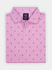 A folded pink polo shirt with a pattern of small navy blue crossed golf clubs. It features a buttoned placket and collar