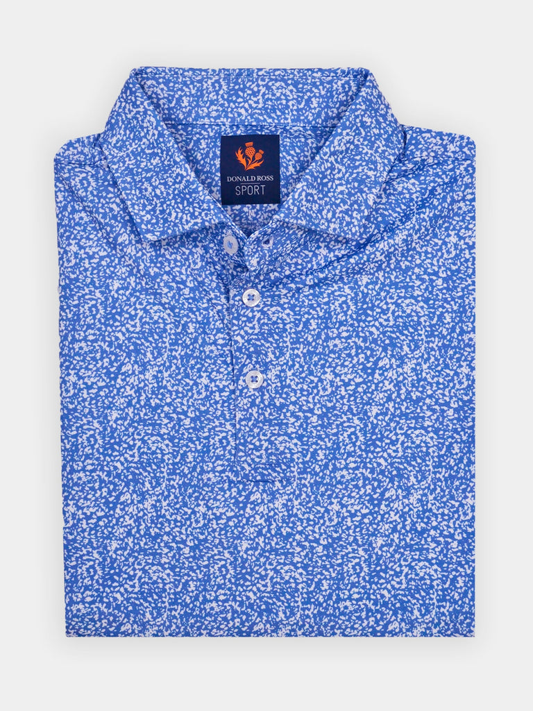 Folded blue golf polo shirt with white sponge pattern, featuring a button placket