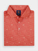 A folded coral-red button-up shirt with a subtle tequila pattern