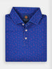 Folded blue golf polo shirt with small pink palm tree and sun patterns