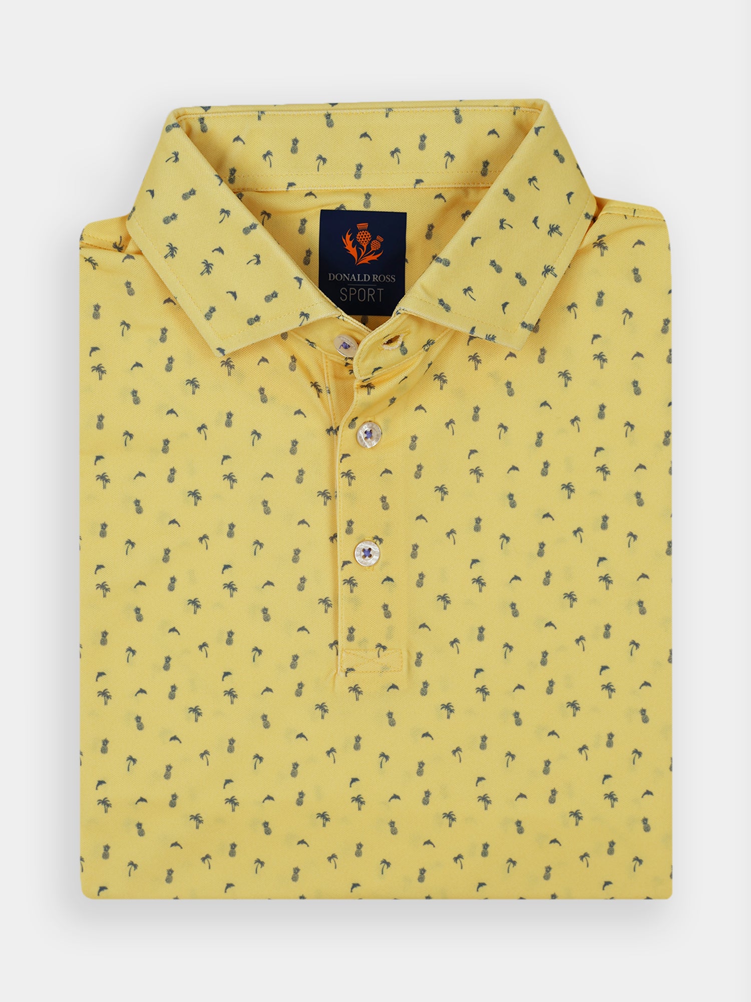 Yellow polo shirt with a folded collar featuring a tropical pattern of small black pineapples, palm trees, and dolphins