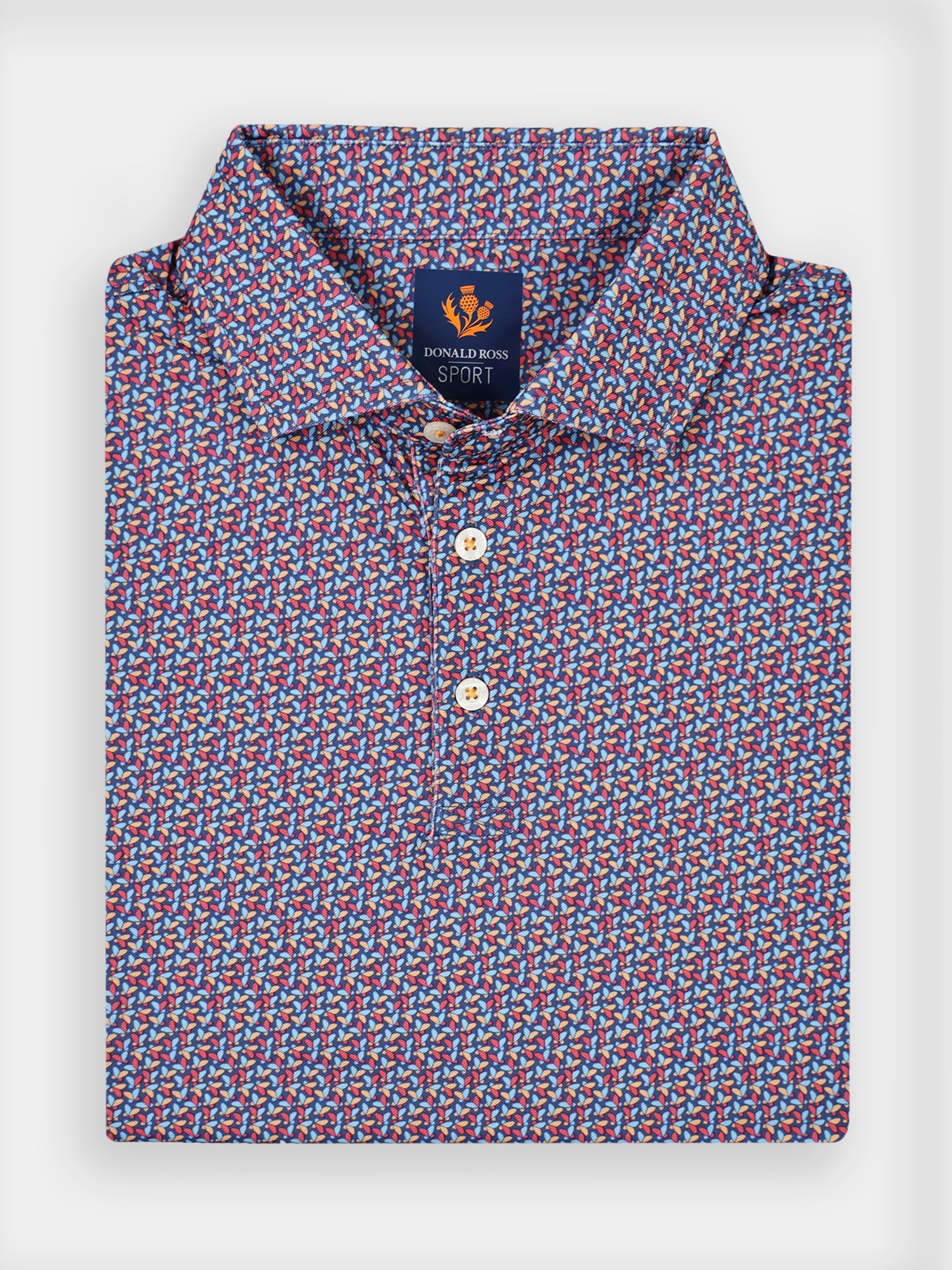 Folded polo shirt with a vibrant butterfly pattern in red, blue, and white