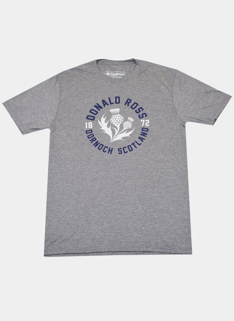 Gray T-shirt featuring a navy blue and white design with the text "Donald Ross, Dornoch Scotland, 1872" around a stylized thistle graphic