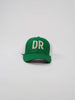 Green trucker hat with white mesh sides featuring large, bold letters "DR" in cream on the front
