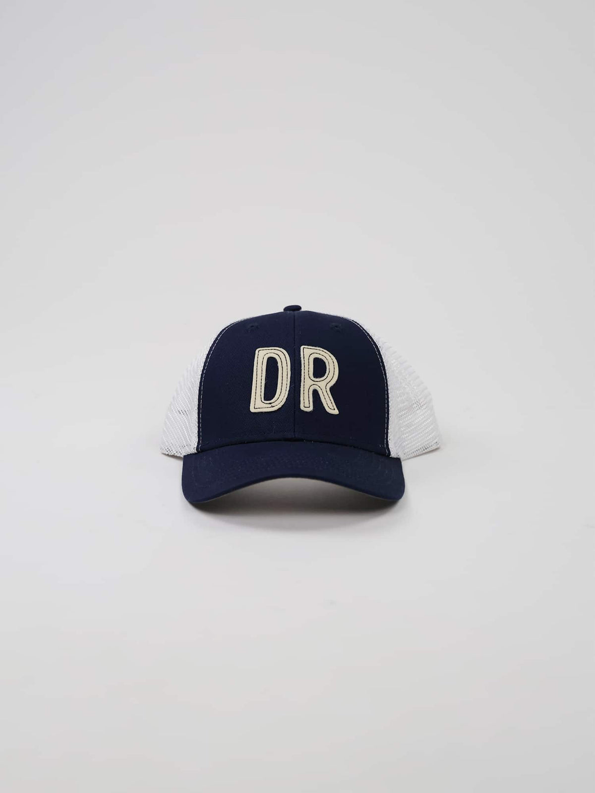 Navy blue and white trucker cap with "DR" in large stitched letters on the front