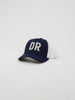 A navy blue baseball cap with white mesh back, displaying bold white letters "DR" on the front