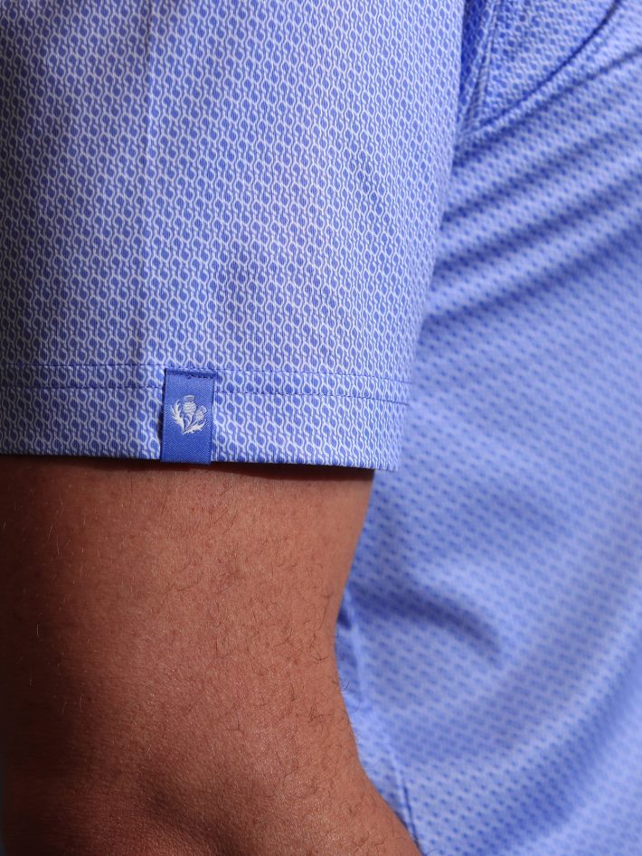 Close-up of the sleeve on a men's wishbone print polo.